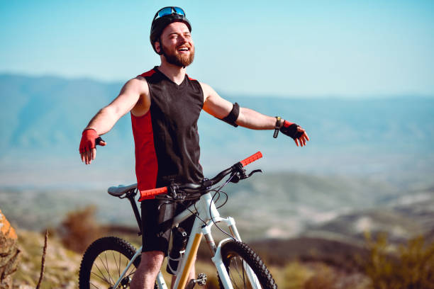 istock Smiling Male Cyclist Enjoying Mountain Freedom On Journey 1320002520