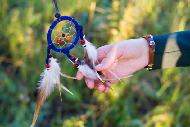 istock Dreamcatcher and girl hands with sunset in the forest 1320003950