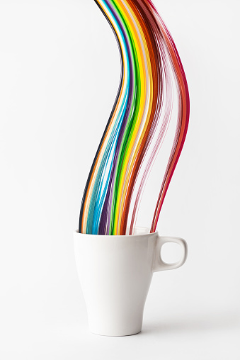 Drinking cup decorated with a rainbow pride flag on white background