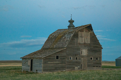 Picturesque old wooden barn on central Montana prairie near Roundup, Montana. Largest cities nearby are Billings and Bozeman, Montana