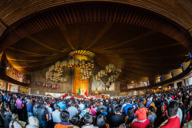 People Gather During Mass Inside the Famous Basilica of Our Lady of Guadalupe in Mexico City, Mexico Mexico City, Mexico - January 7, 2019: People gather during mass inside the famous Basilica of Our Lady of Guadalupe in Mexico City, Mexico. altar photos stock pictures, royalty-free photos & images