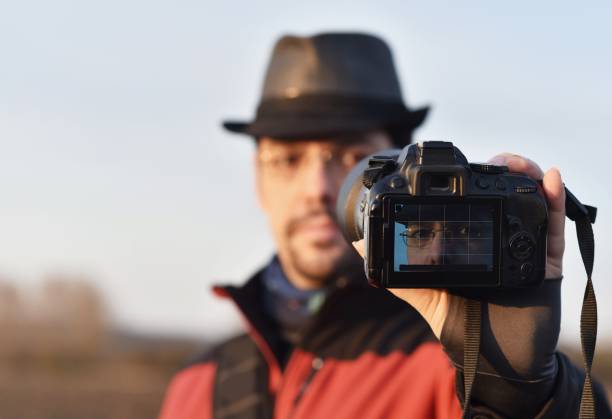 istock man takes a selfie photo on a dslr camera 1320005372