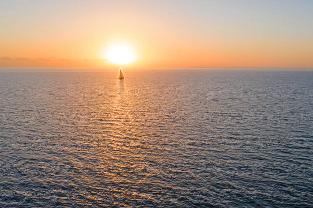 istock Aerial from sailing on the ocean at sunset 1320006278