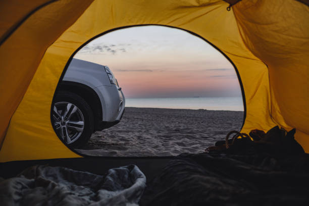istock view through the camping tent at suv car and sandy sea beach 1320008184