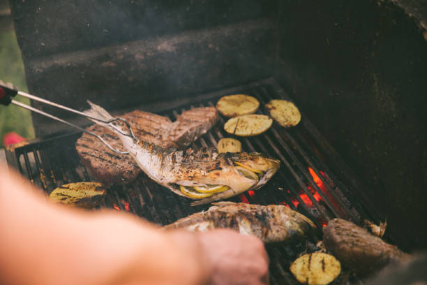 istock cooking fish and potatoes on grill 1320008215