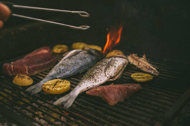 istock cooking fish and potatoes on grill 1320008218