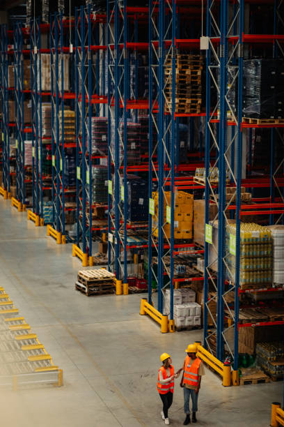 istock Two colleagues standing together in a factory 1320009767
