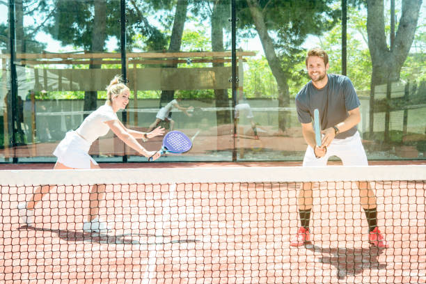 mixed couple plays on a padel court stock photo