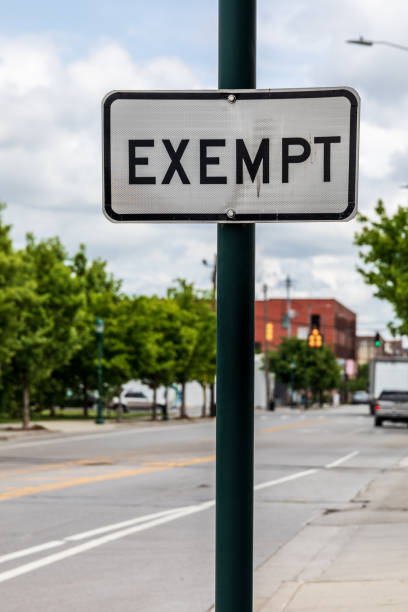 "EXEMPT" road sign Chattanooga, TN, USA-10 May 2021: A black and white "exempt' sign indicating railroad track crossing the road is out of service. tennessee road sign stock pictures, royalty-free photos & images