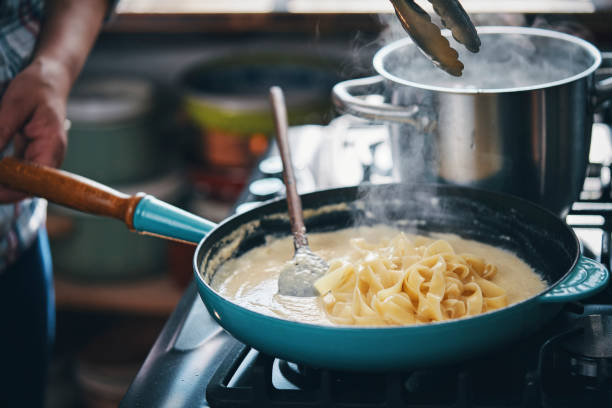 istock Preparing Fettuccine Pasta Alfredo 1320013896