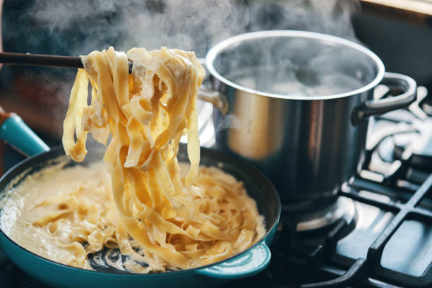 istock Preparing Fettuccine Pasta Alfredo 1320013954