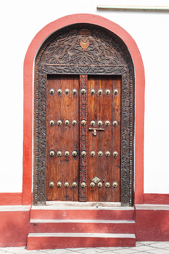 Traditional wooden door in Stone Town, Zanzibar, Tanzania. Stone Town was designated as a UNESCO World Heritage Site in 2000