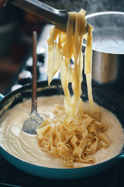 istock Preparing Fettuccine Pasta Alfredo 1320014284