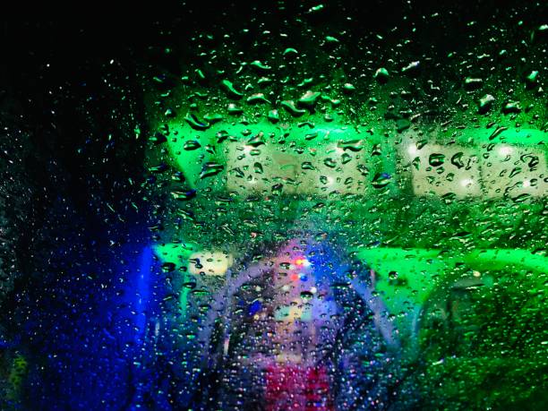 istock Rain drops of water on a colourful glass surface 1320014288