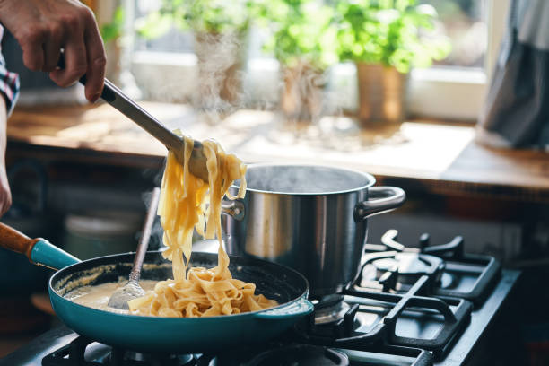 istock Preparing Fettuccine Pasta Alfredo 1320014365