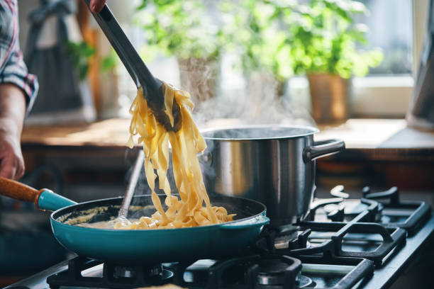 istock Preparing Fettuccine Pasta Alfredo 1320014412