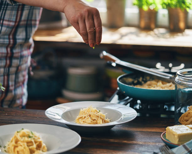istock Preparing Fettuccine Pasta Alfredo 1320014571