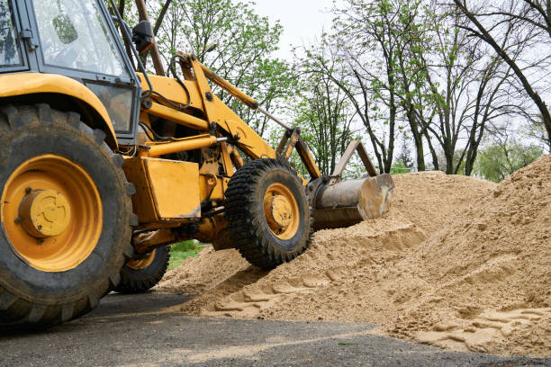 istock tractor or bulldozer works with a pile of sand for construction 1320014818