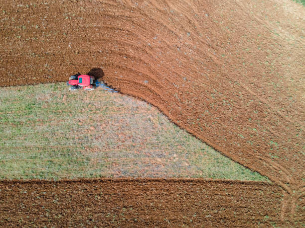 istock Aerial View. Tractor Plowing Field In Spring Season 1320015873