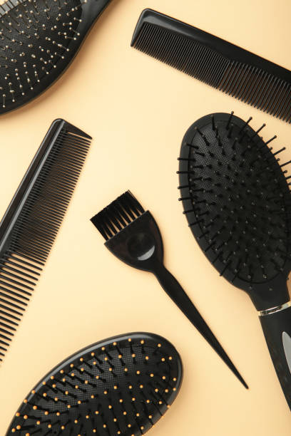 istock Hair tools, beauty and hairdressing concept - different brushes or combs on beige background. Vertical photo 1320016222
