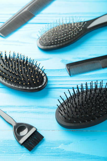 istock Hair tools, beauty and hairdressing concept - different brushes or combs on blue background. Vertical photo 1320016897