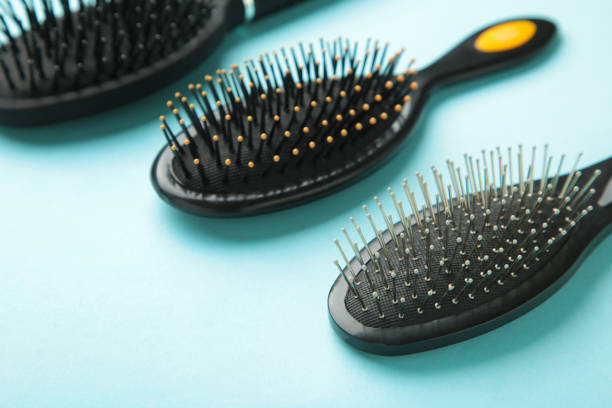 istock Hair tools, beauty and hairdressing concept - different brushes or combs on blue background 1320017041