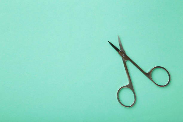 istock Small metal manicure scissors on mint background with copy space 1320017058