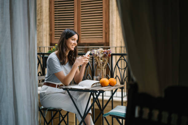 istock Young woman relaxes on balcony in old village 1320020721