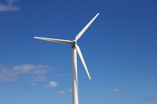 Close-up of a wind turbine in use for environment friendly production of electric energy.