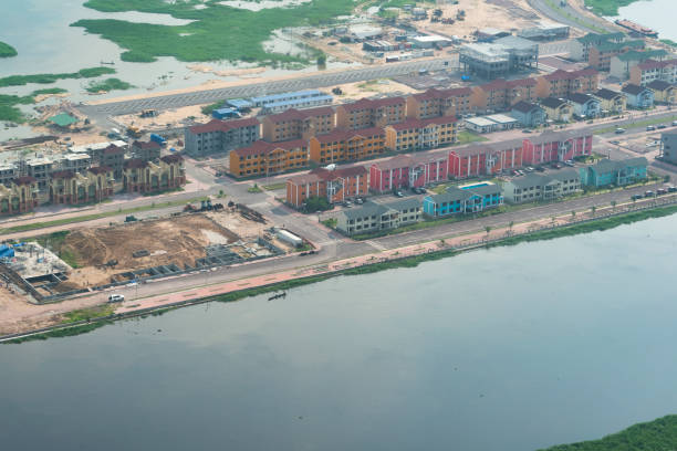 Aerial view of a construction site of a planned residential area on an island in the Congo River Kinshasa, Democratic Republic of Congo - December 13, 2014:
Aerial view of an artificial island in the Congo River, on which the satellite city "La cité du Fleuve" is being built. "La cité du Fleuve" is a planned development situated on reclaimed land space in the sandbanks and marshes of the Congo river, directly adjacent to Kinshasa in the Democratic Republic of Congo (DRC). kinshasa stock pictures, royalty-free photos & images