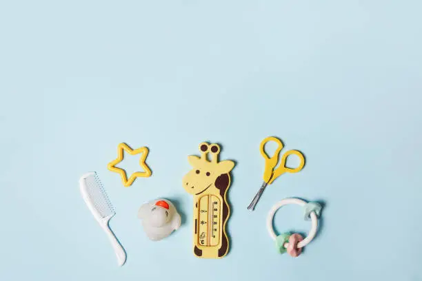Baby accessories on blue background with copy space