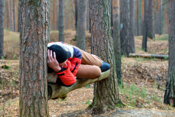 istock a man resting in the park lies on a bench in a pine forest 1320028305