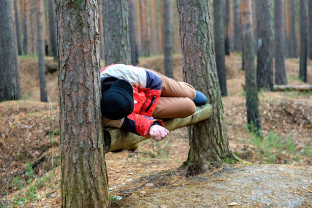 istock sleeping man on a bench in the forest in autumn time 1320028307