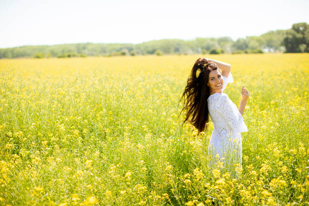 istock Young woman in the rapeseed field 1320035077