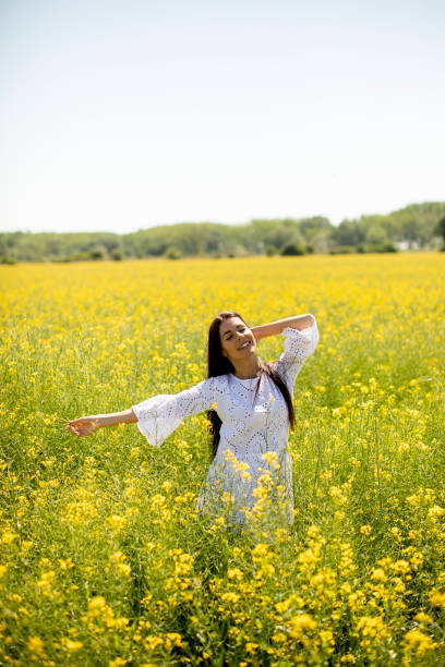 istock Young woman in the rapeseed field 1320035113