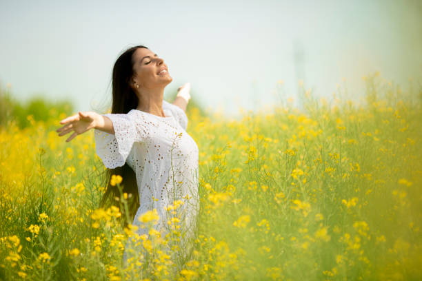 istock Young woman in the rapeseed field 1320035122