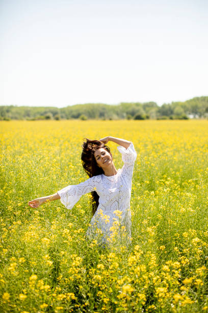istock Young woman in the rapeseed field 1320035136