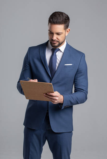 クリップボードにメモを作るビジネスマン ストックフォト