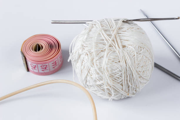 istock White tangle of threads with spokes and a centimeter on a white background. 1320038374