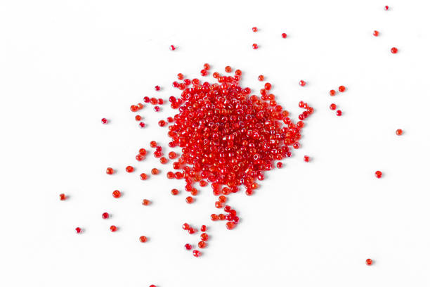 istock Scattered pile of red beads on a white background. 1320038388