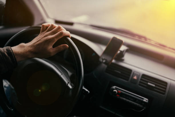 istock driver drives a car on a sunny day 1320038426