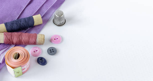 istock Accessories for sewing: coils of threads, buttons, thimble and centimeter on a white background. Copy space. 1320038448