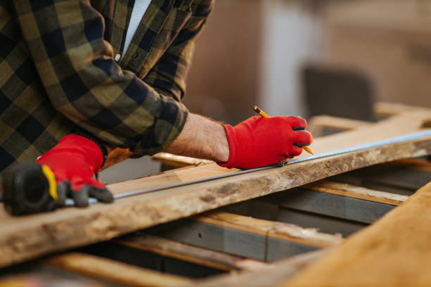 istock Close up of unrecognizable worker drawing on wood plank. 1320041037