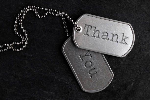 Old military dog tags - Thank You Old and worn military dog tags - Thank You veteran stock pictures, royalty-free photos & images