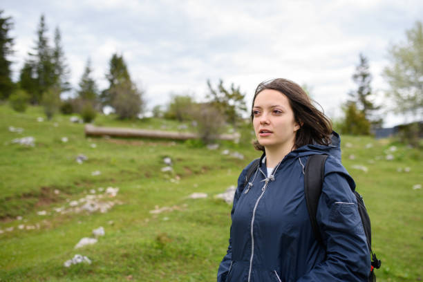 istock portrait of a woman hiking with a backpack on her back. 1320042378