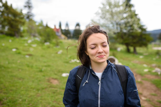 istock portrait of a woman hiking with a backpack on her back. 1320042473