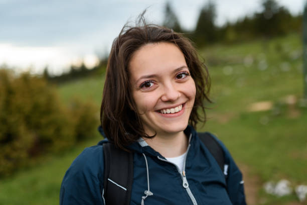 istock portrait of a woman hiking with a backpack on her back. 1320042639