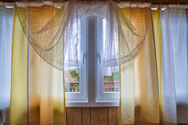 istock Scandinavian interior, white and yellow curtains and windows 1320043512