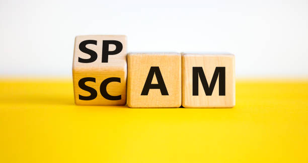 istock Spam and scam symbol. Turned a wooden cube and changed the word 'scam' to 'spam' or vice versa. Beautiful yellow table, white background, copy space. Business, spam and scam concept. 1320043621