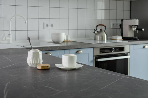 istock Modern stylish blue and gray kitchen with tea and coffee making facilities 1320044418